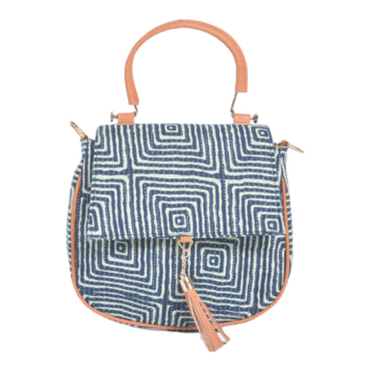 A blue handcrafted handbag with a geometric pattern and a tan leather-like detachable crossbody strap, featuring a tassel detail and secure magnetic clasp.
