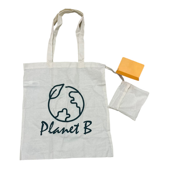 Off-white cotton tote bag with 'Planet B' printed on the front, accompanied by a foldable pocket. The bag is displayed alongside its packaging tag.