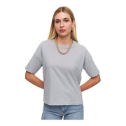 A woman wearing a gray, short-sleeved, crew neck cotton t-shirt with a high neckline.