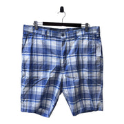 Men's navy blue plaid chino-style shorts with a zipper and button closure, belt loops, and multiple pockets.