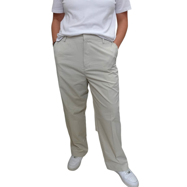 A pair of beige slim fit chino-style pants by Adidas, featuring a classic straight-leg design with double side and back pockets, belt loops, and a modern tapered fit.