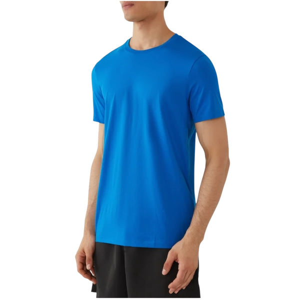 Men’s blue crew neck T-Shirt by Armani Exchange with short sleeves and athletic fit, shown in angled view on model