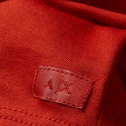 Detailed close-up of red stretch cotton fabric and A|X logo tag on Armani Exchange T-Shirt