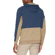 Model wearing Columbia men's hoodie in beige and navy blue, shown from the back with two-tone hood design