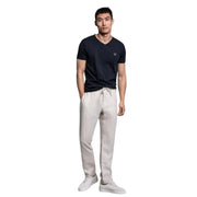 GANT black V-neck T-shirt full body front view worn by model with white drawstring pants and sneakers