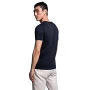 GANT black V-neck T-shirt back view worn by model in white pants