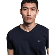 GANT black V-neck T-shirt close-up of embroidered chest logo worn by model