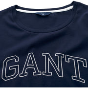Close-up of GANT arched white logo print on navy T-shirt – ribbed crewneck and premium cotton.