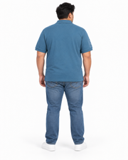 Back view of a man wearing a blue grey Giordano ribbed polo shirt with short sleeves and a slim fit.