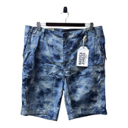 Men's mid-rise cargo shorts with a print dye design in naval blue, displayed on a hanger with tags attached.