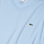 Close-up of Lacoste light blue V-neck T-Shirt logo and stitching on chest