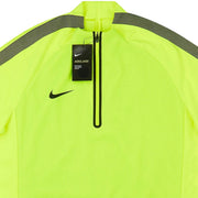 Close-up of Nike Aerolayer tag and logo on fluorescent yellow men's training top