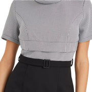 Close-up of Styli pencil dress showing mini houndstooth pattern and belted waist detail