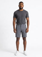 The Discount District men's dark brown cotton chino shorts with zip pockets and regular fit, worn by a model.