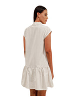 The Discount District off-white linen mini dress with a collared neckline and flowy drop-waist skirt, back view.