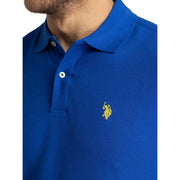 US Polo Assn. royal blue polo shirt with yellow logo embroidery close-up view